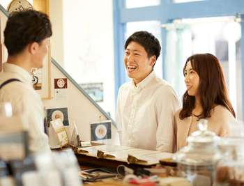 Merchant and customer smiling together